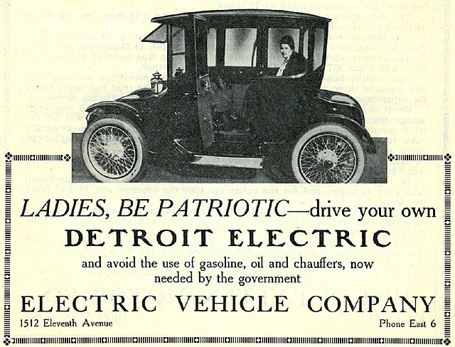 An old ad for a Detroit Electric vehicle by Electric Vehicle Company that says: "Ladies, be patriotic—drive your own Detroit Electric and avoid the use of gasoline, oil and chauffers, now needed by the government." Above the text is a woman in the advertised vehicle.